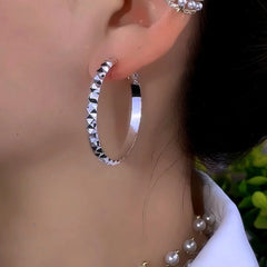 Close-up detail of the sparkling zircons and plating on the Large Hoop Earrings