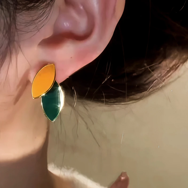 Angled view of the 14K Gold-Plated Elegant Leaf Pearl Tassel Earrings