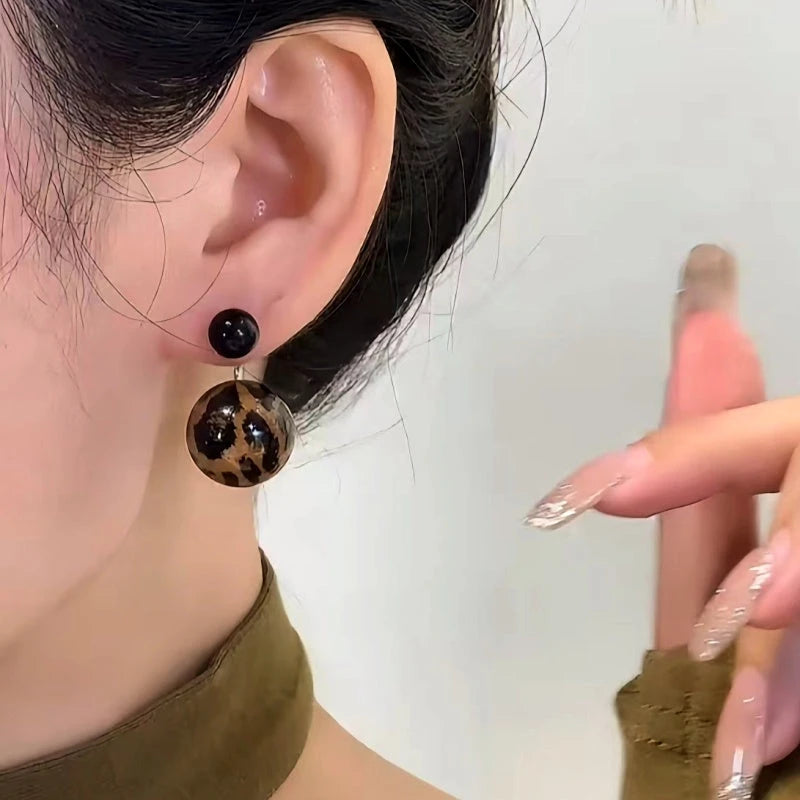 Close-up detail of the sparkling zircons and plating on the Leopard Print Bead Earrings