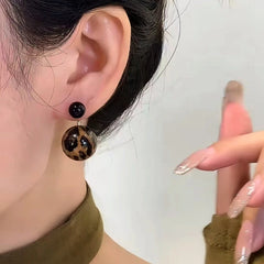 Close-up detail of the sparkling zircons and plating on the Leopard Print Bead Earrings