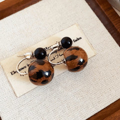 Angled view of the 14K Gold-Plated Elegant Leopard Print Bead Earrings