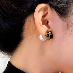 Model showcasing the dangle and style of the 14K Gold-Plated Elegant Leopard Print Five-Pointed Star Pearl Earrings