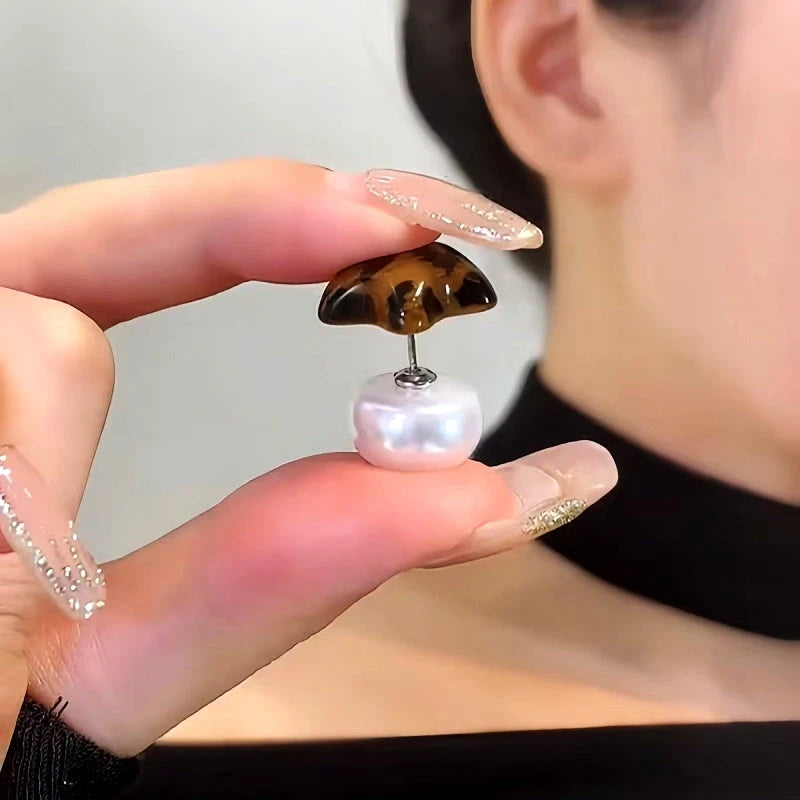 Angled view of the 14K Gold-Plated Elegant Leopard Print Five-Pointed Star Pearl Earrings