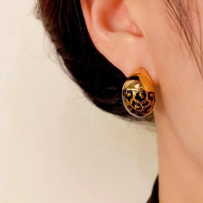 Model showcasing the dangle and style of the 14K Gold-Plated Elegant Leopard Print Half-Circle Earrings