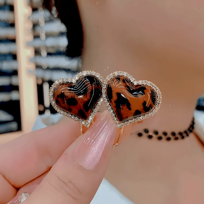 Close-up detail of the sparkling zircons and plating on the Leopard Print Heart Earrings