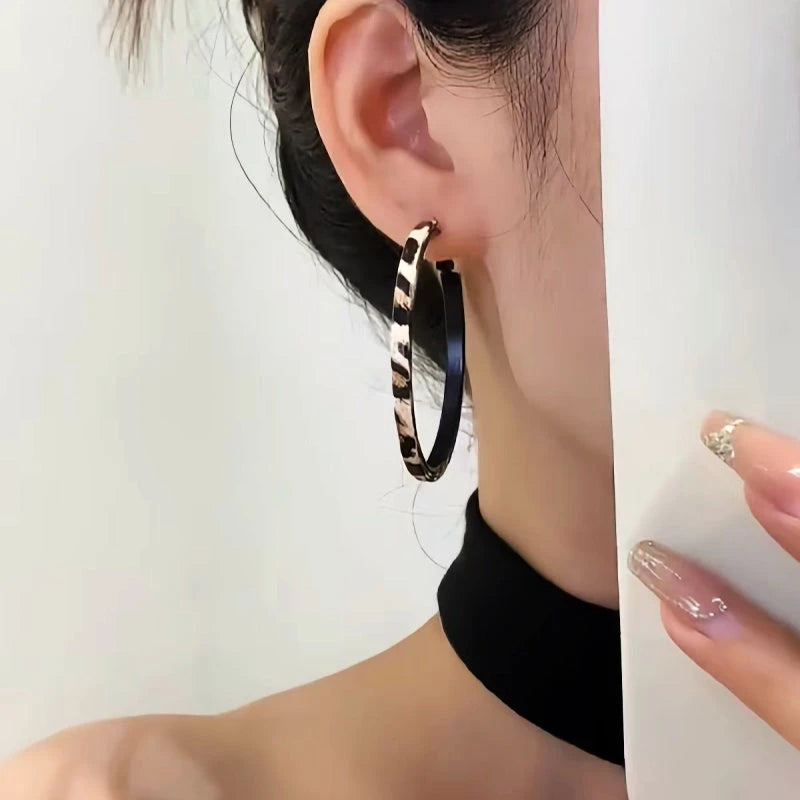 Close-up detail of the sparkling zircons and plating on the Leopard Print Hoop Earrings