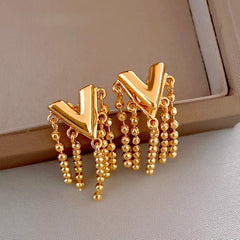 Close-up detail of the sparkling zircons and plating on the Letter V Tassel Earrings