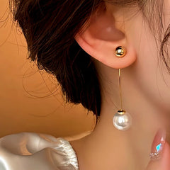 Model showcasing the dangle and style of the 14K Gold-Plated Elegant Long Arc Pearl Earrings