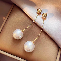Close-up detail of the sparkling zircons and plating on the Long Arc Pearl Earrings
