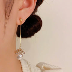 Model showcasing the dangle and style of the 14K Gold-Plated Elegant Long Pearl Earrings