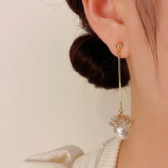 Angled view of the 14K Gold-Plated Elegant Long Pearl Earrings