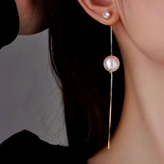 Model showcasing the dangle and style of the 14K Gold-Plated Elegant Long Pearl Tassel Earrings
