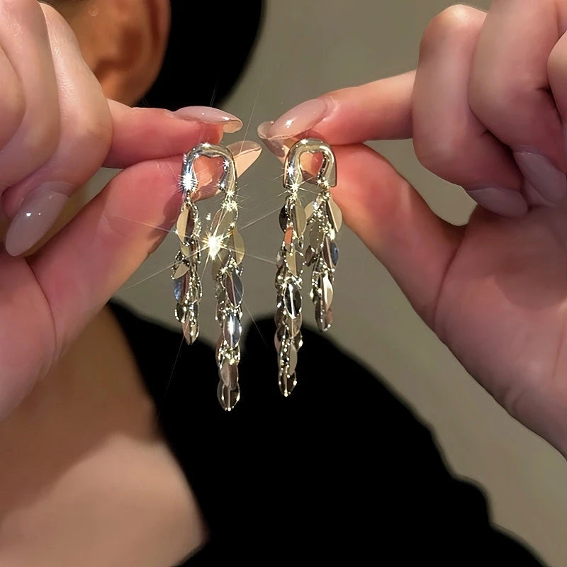 Model showcasing the dangle and style of the 14K Gold-Plated Elegant Long Tassel Earrings