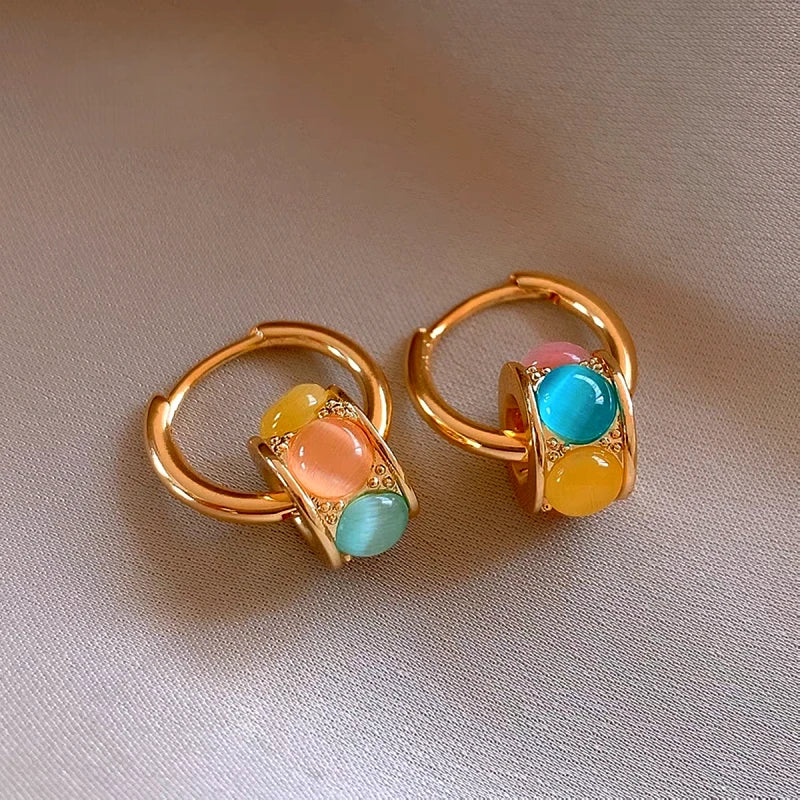 Model showcasing the dangle and style of the 14K Gold-Plated Elegant Luxury Cat's Eye Stone Earrings