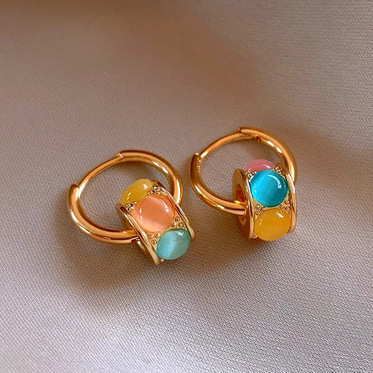 Model showcasing the dangle and style of the 14K Gold-Plated Elegant Luxury Cat's Eye Stone Earrings