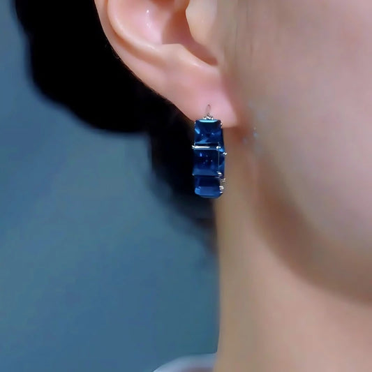 Model showcasing the dangle and style of the 14K Gold-Plated Elegant Luxury Sea Blue Zircon Diamoond Hoop Earrings