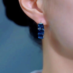 Model showcasing the dangle and style of the 14K Gold-Plated Elegant Luxury Sea Blue Zircon Diamoond Hoop Earrings