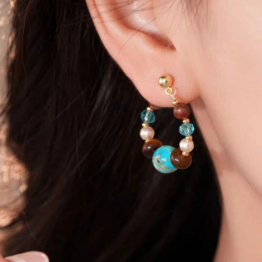 Model showcasing the dangle and style of the 14K Gold-Plated Elegant Luxury Stone Pearl Earrings