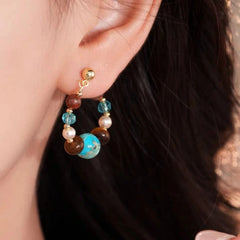 Close-up detail of the sparkling zircons and plating on the Stone Pearl Earrings