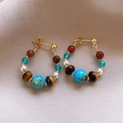 Angled view of the 14K Gold-Plated Elegant Luxury Stone Pearl Earrings