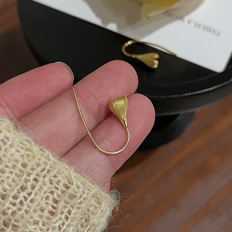 Angled view of the 14K Gold-Plated Elegant Magnolia Ear Hook Earrings