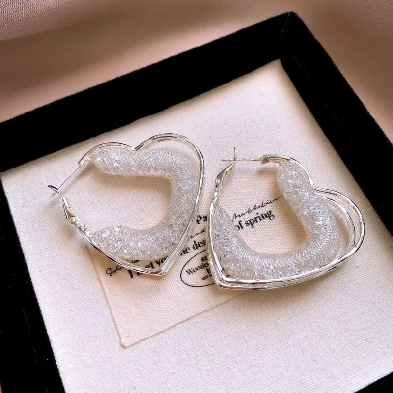 Close-up detail of the sparkling zircons and plating on the Mesh Heart Earrings