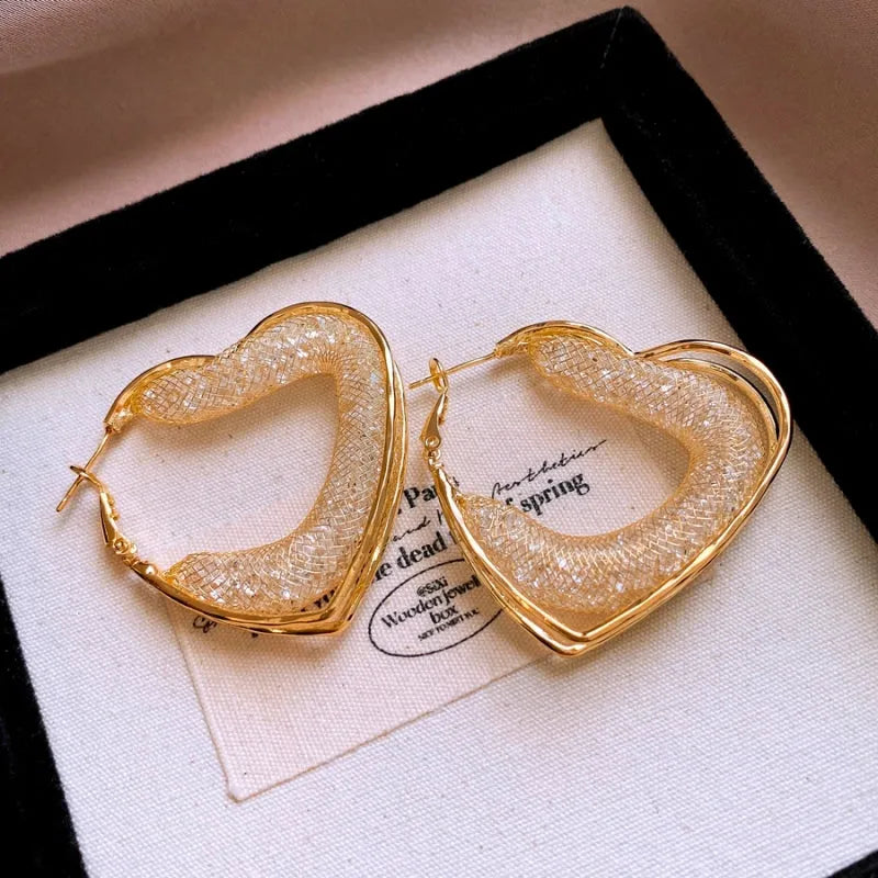 Angled view of the 14K Gold-Plated Elegant Mesh Heart-Design Earrings