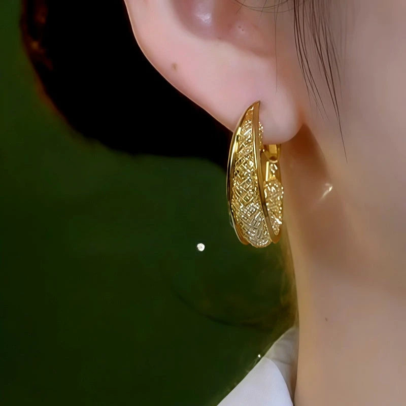 Model showcasing the dangle and style of the 14K Gold-Plated Elegant Mesh Hoop Earrings