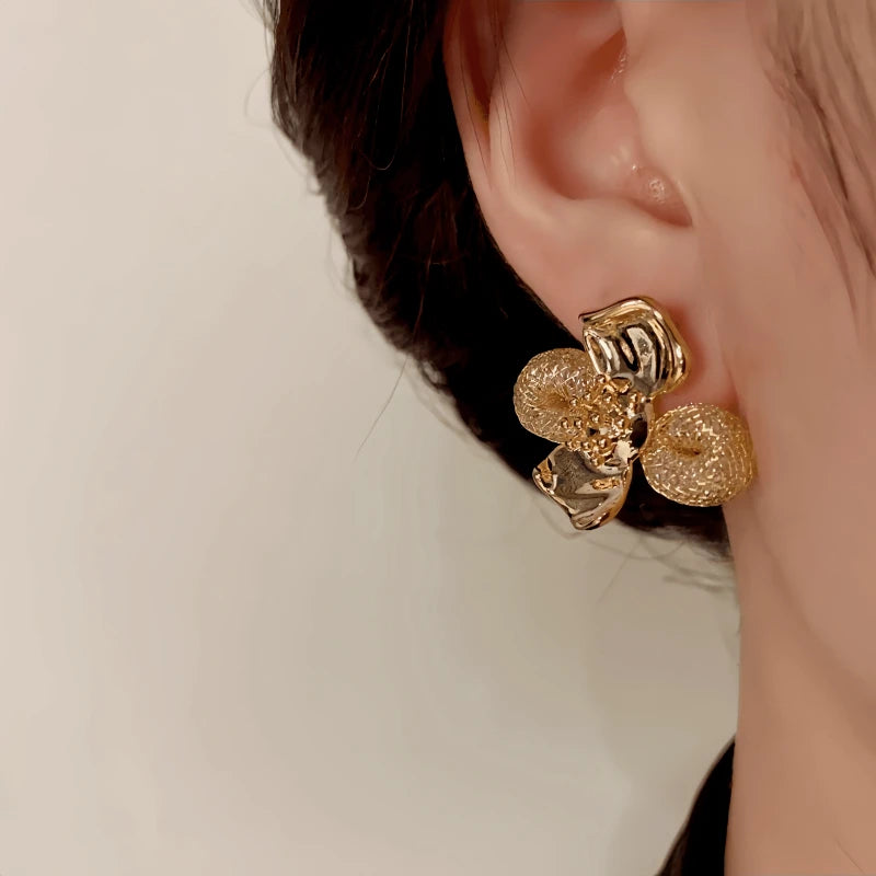 Model showcasing the dangle and style of the 14K Gold-Plated Elegant Mesh Petal Flower Stud Earrings