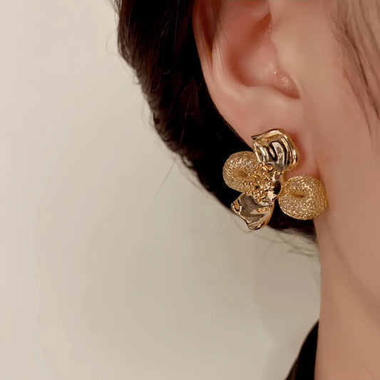 Model showcasing the dangle and style of the 14K Gold-Plated Elegant Mesh Petal Flower Stud Earrings