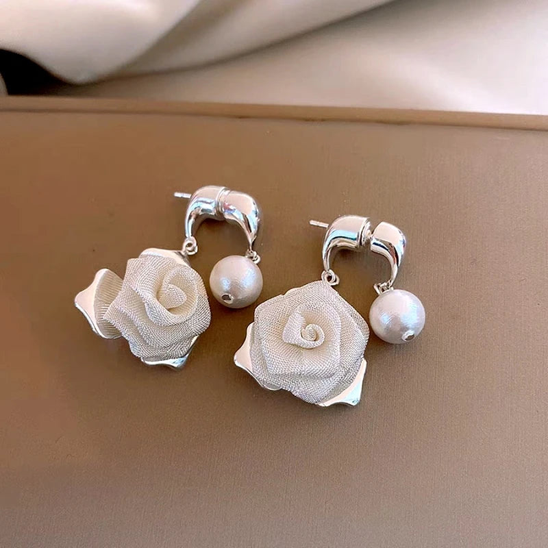 Close-up detail of the sparkling zircons and plating on the Rose Cross Earrings