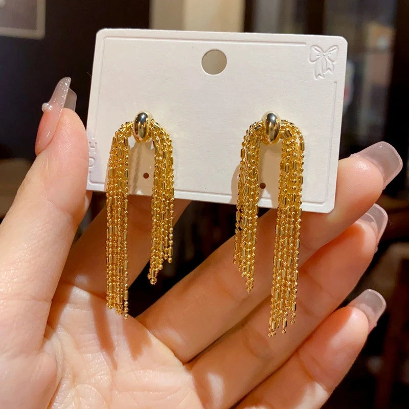 Close-up detail of the sparkling zircons and plating on the Long Chain Tassel Earrings