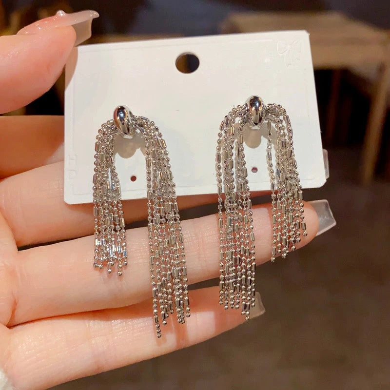 Angled view of the 14K Gold-Plated Elegant Metal Long Chain Tassel Earrings