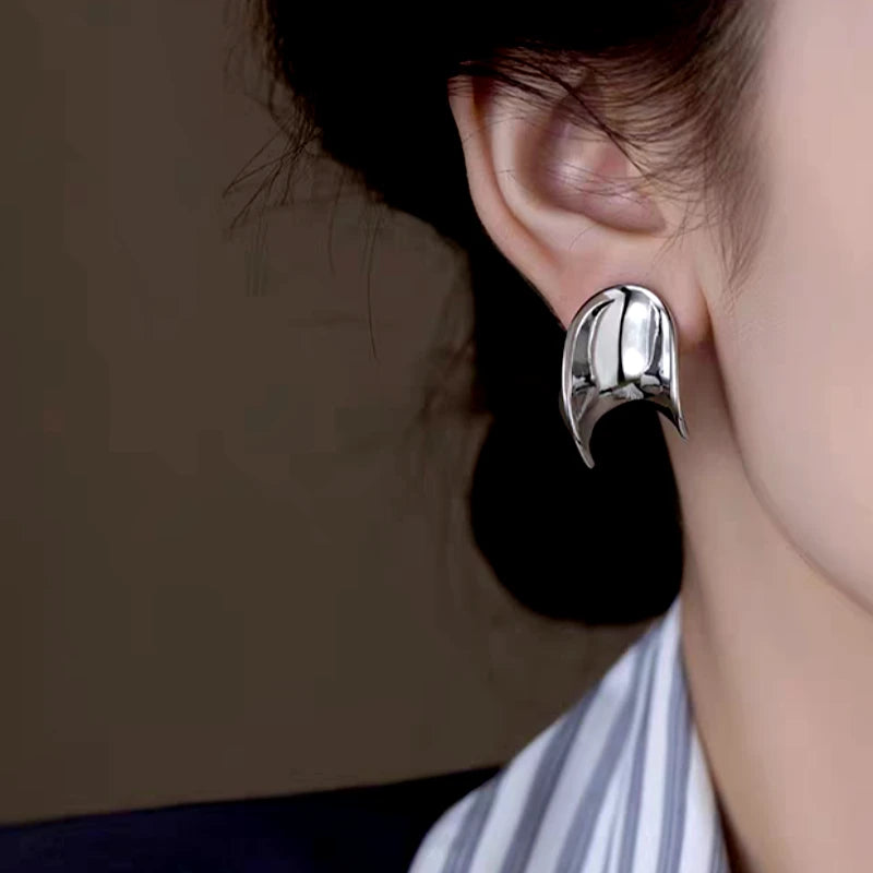 Model showcasing the dangle and style of the 14K Gold-Plated Elegant Minimalist Metal Spiral Earrings