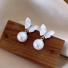 Model showcasing the dangle and style of the 14K Gold-Plated Elegant Mother-Of-Pearl Butterfly Earrings