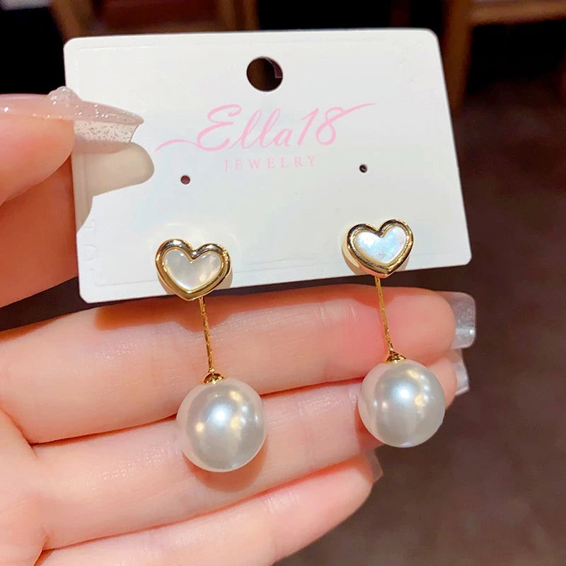 Close-up detail of the sparkling zircons and plating on the Mother of Pearl Heart Earrings