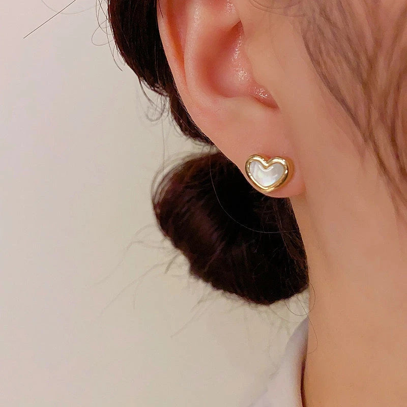 Angled view of the 14K Gold-Plated Elegant Mother-Of-Pearl Heart Earrings
