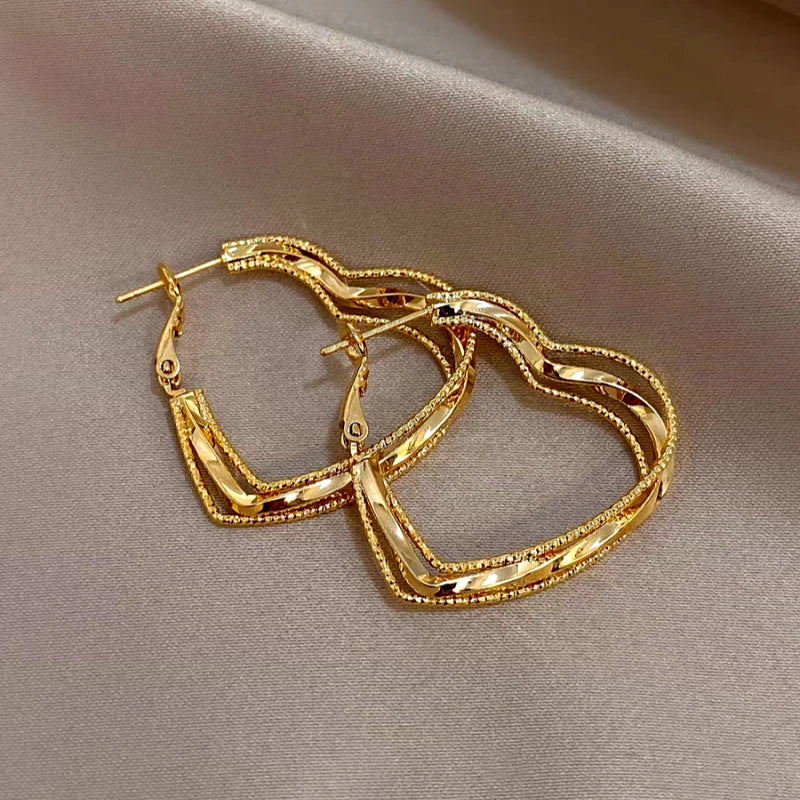 Close-up detail of the sparkling zircons and plating on the Multi-Layer Heart Earrings