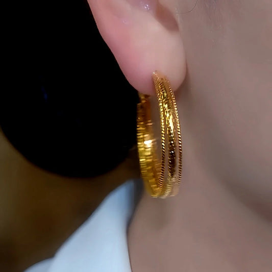 Model showcasing the dangle and style of the 14K Gold-Plated Elegant Multi-Layer Hoop Earrings