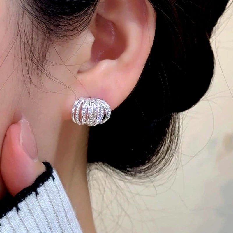 Model showcasing the dangle and style of the 14K Gold-Plated Elegant Multi-Layer Stud Earrings