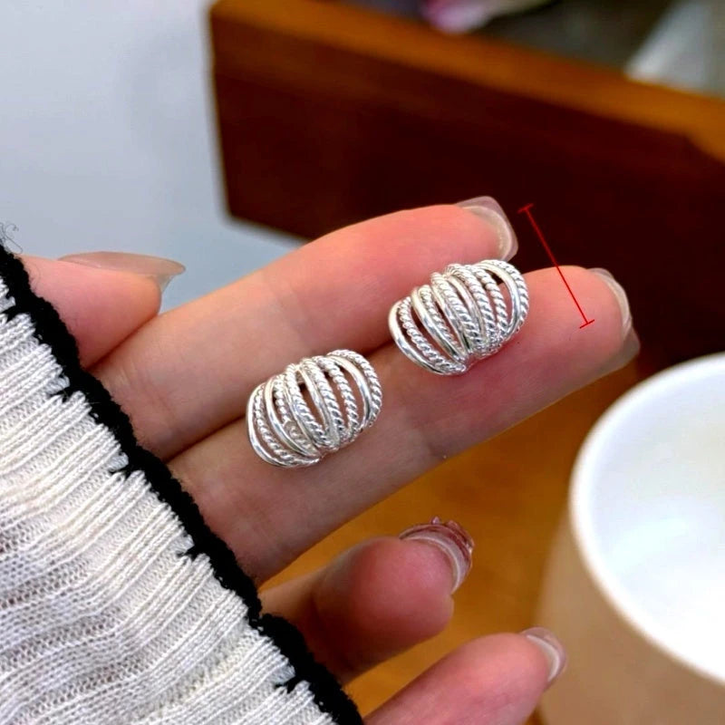 Angled view of the 14K Gold-Plated Elegant Multi-Layer Stud Earrings