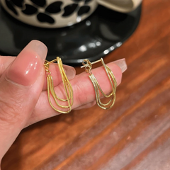 Angled view of the 14K Gold-Plated Elegant Multi-Layer Tassel Earrings