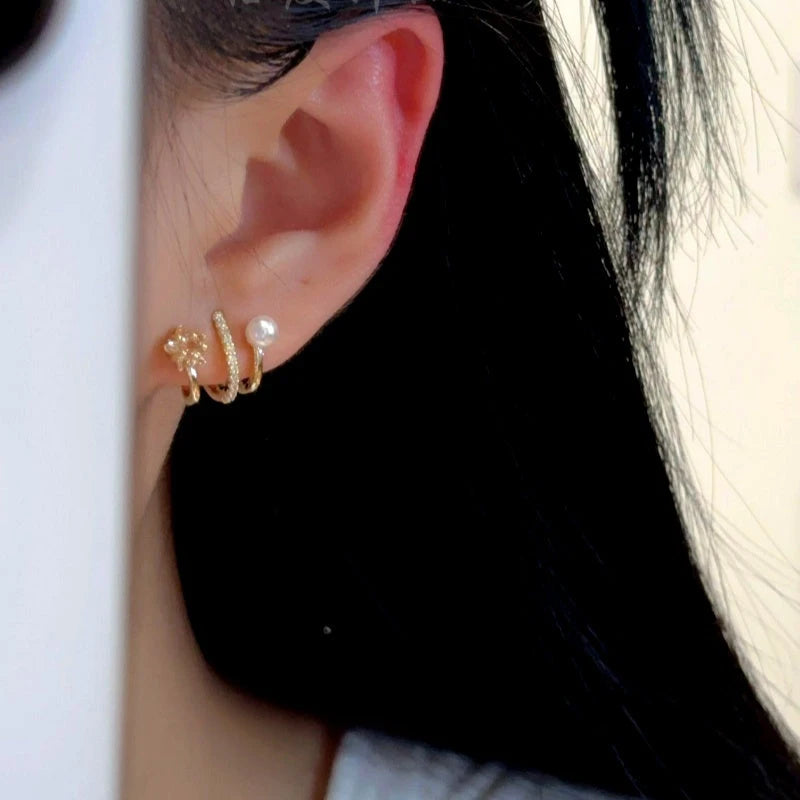 Model showcasing the dangle and style of the 14K Gold-Plated Elegant Multi-Layer Zircon Star Pearl Stud Earrings
