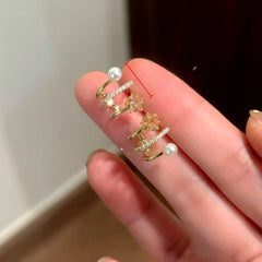 Close-up detail of the sparkling zircons and plating on the Star Pearl Stud Earrings