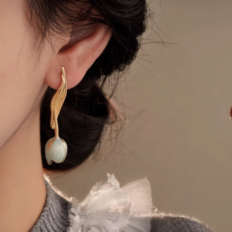 Model showcasing the dangle and style of the 14K Gold-Plated Elegant Oil-Drop Leaf Tulip Earrings