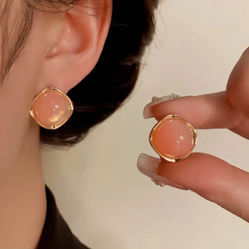 Model showcasing the dangle and style of the 14K Gold-Plated Elegant Oil-Drop Round Geometric Stud Earrings
