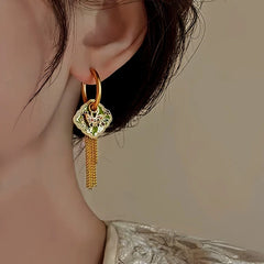 Angled view of the 14K Gold-Plated Elegant Oil Drop Butterfly Tassel Earrings
