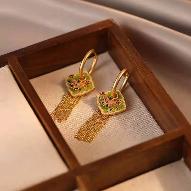 Model showcasing the dangle and style of the 14K Gold-Plated Elegant Oil Drop Butterfly Tassel Earrings