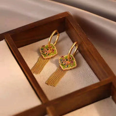 Model showcasing the dangle and style of the 14K Gold-Plated Elegant Oil Drop Butterfly Tassel Earrings