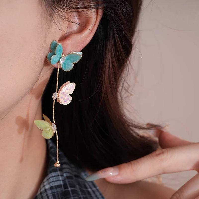 Model showcasing the dangle and style of the 14K Gold-Plated Elegant Oil Drop Colorful Butterfly Tassel Earrings